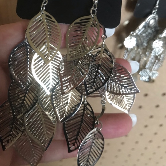 Multiple silver feather design drop earrings.